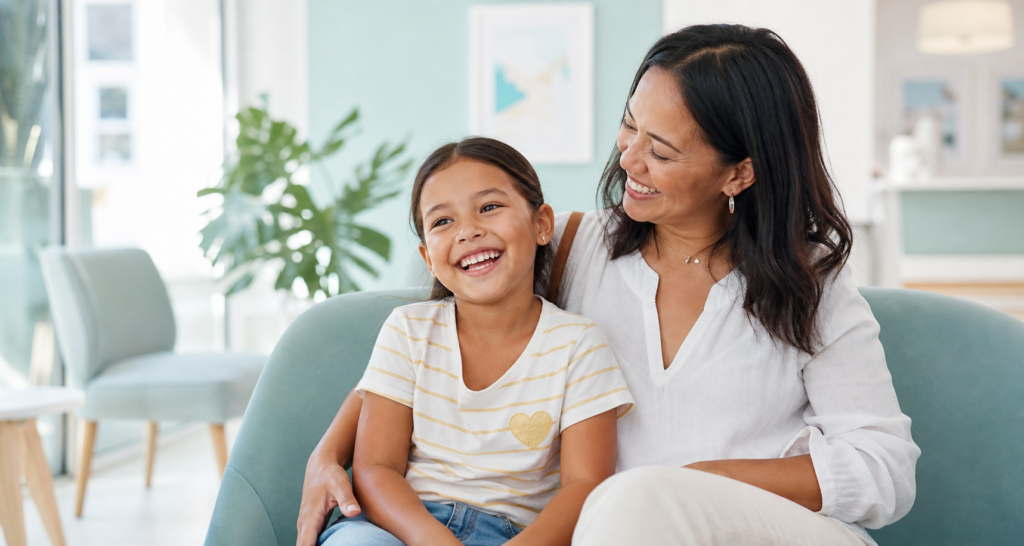 Happy child relaxing with her mother in a bright child-friendly dental clinic