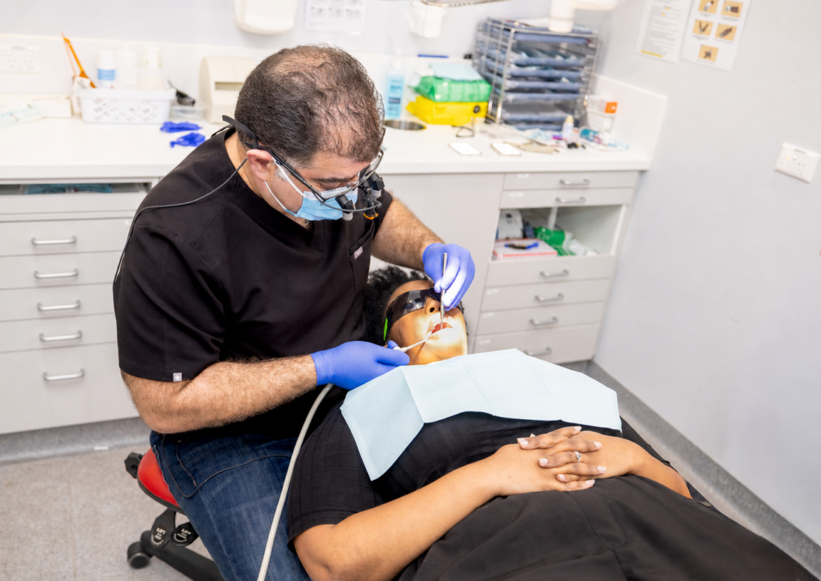 Dr Ehsan Al-Kajbaf providing dental treatment Dr Ehsan Al-Kajbaf providing dental treatment at Smile and Shine Dental Clinic